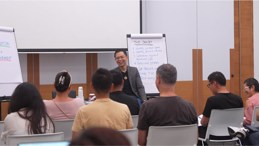 Stuart Tan speaking with a small group